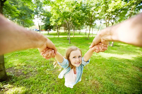 夏の日の公園で彼女の親がぐるぐるされてうれしそうな子 — ストック写真