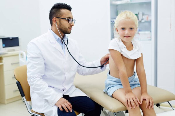 Adorable child havin examination of her lungs and breath in clinics