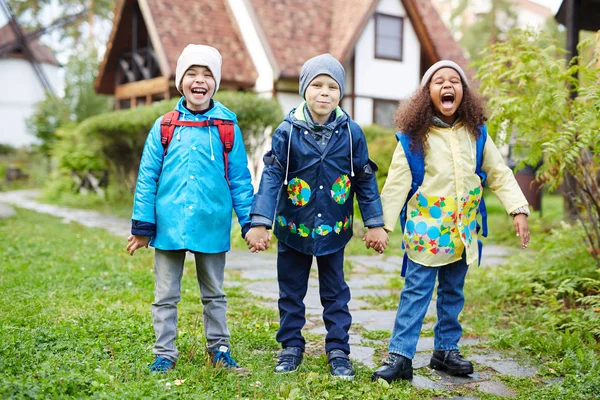 Three Happy Little Schoolkids Backpacks One Them African Standing Holding — Stock Photo, Image