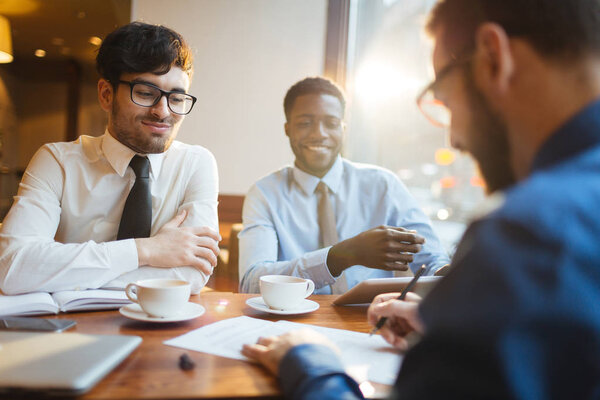 Businessman signing contract with partners