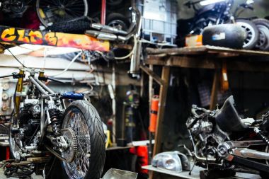 Background image  of disassembled motorcycle ready for repairing in mechanics garage clipart