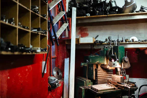 Background image of empty workshop in plant, cutting machine and shelves with metal parts