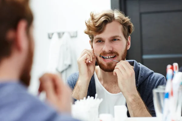 Young Man Flossing His Teeth Front Mirror — Stock Photo, Image