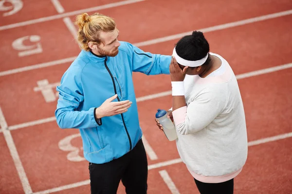 Personal Trainer Consoling Tired Overweight Client Running Practice Track Field — Stock Photo, Image