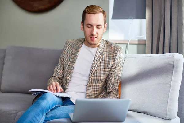 Businessman organizing work or analyzing online data in home office