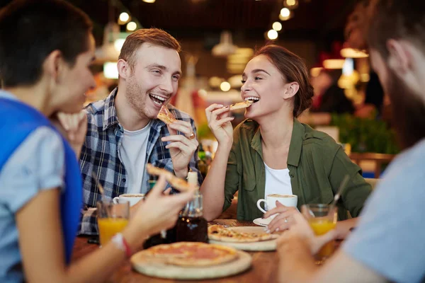 Grupo Amigos Alegres Comiendo Deliciosa Pizza Charlando Animadamente Mientras Reúnen — Foto de Stock