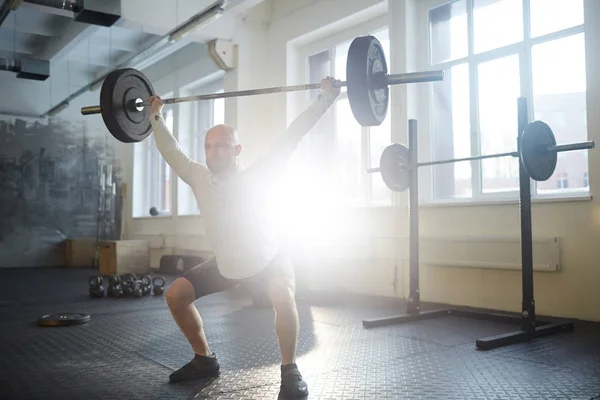Sportsman Squatting While Lifting Heavy Barbell — Stock Photo, Image