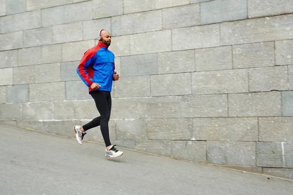 Young Sprinter Headphones Running Wall — Stock Photo, Image