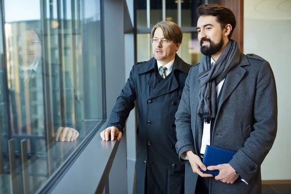 Confident Middle Aged Businessmen Wearing Coats Standing Office Lobby Looking — Stock Photo, Image