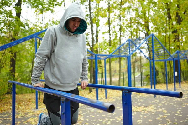 Young Sportsman Hoodie Doing Street Workout Exercise Legs Bent Knee — Stock Photo, Image
