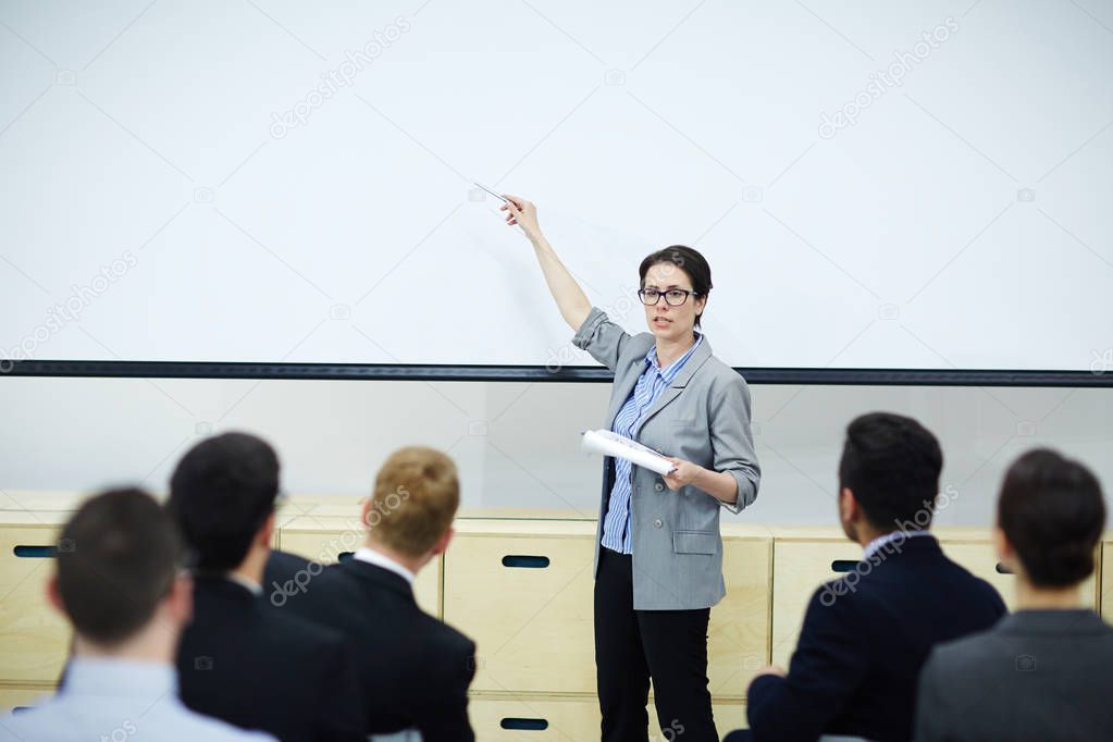 Business expert explaining new trends on whiteboard