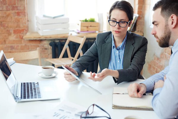 Small group of traders analyzing online statistics