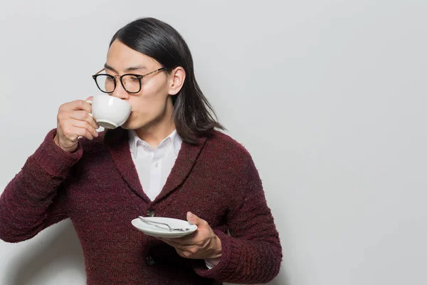 Young Asian Man Holding Saucer Spoon While Sipping Hot Drink — Stock Photo, Image