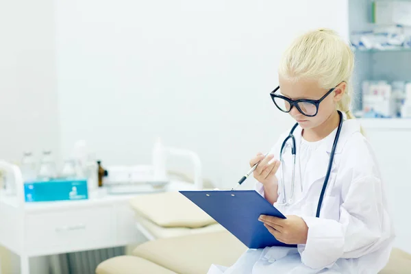Little Girl Eyeglasses Whitecoat Reading Medical Document While Playing Doctor — Stock Photo, Image