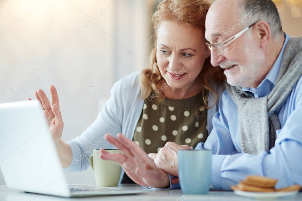 Affectionate couple watching online video in the net