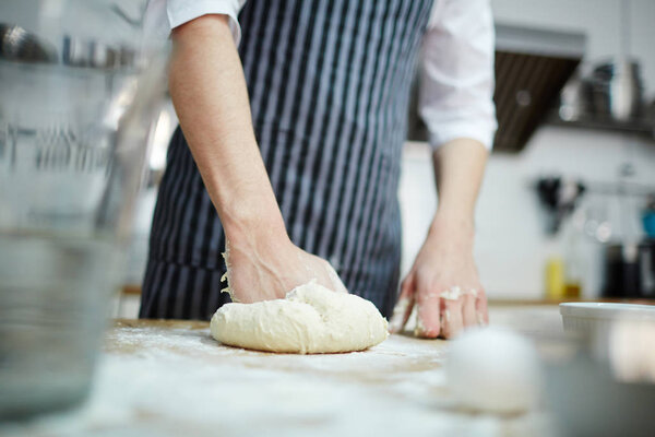 Pastry chef preparing  fresh dough for buns
