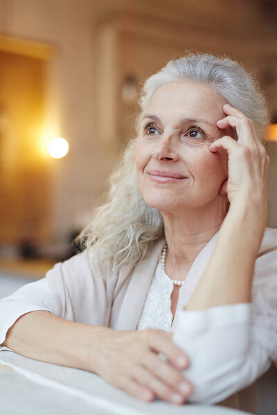 Attractive mature woman enjoying good memories