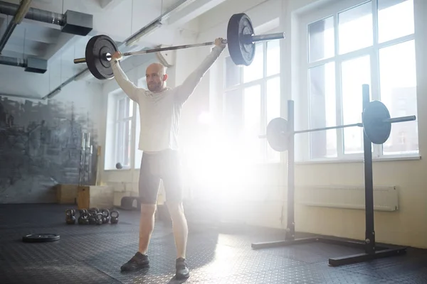 Wide Shot Portrait Modern Bald Strongman Lifting Heavy Barbell Overhead — Stock Photo, Image