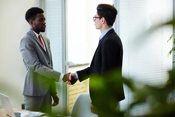 Confident Young Entrepreneurs Standing Modern Boardroom Shaking Hands Successful Completion — Stock Photo, Image