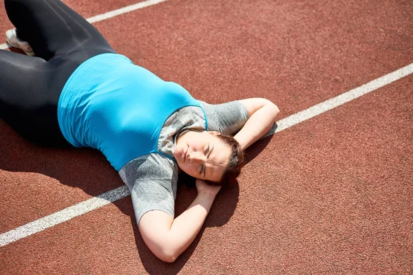 Relaxed Young Chubby Female Lying Stadium Racetrack — Stock Photo, Image