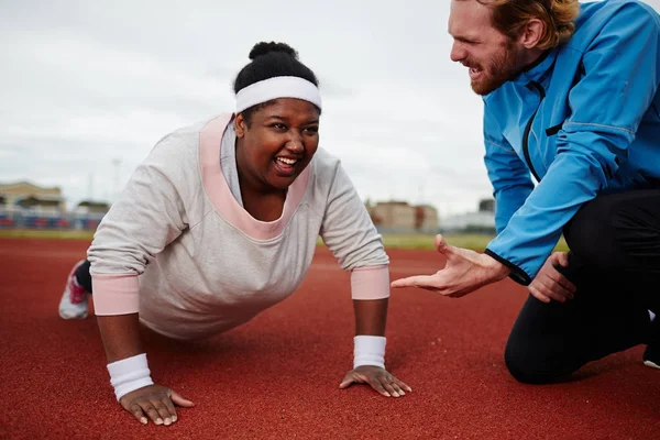 Determined Size Woman Doing Push Ups Motivated Personal Coach — Stock Photo, Image