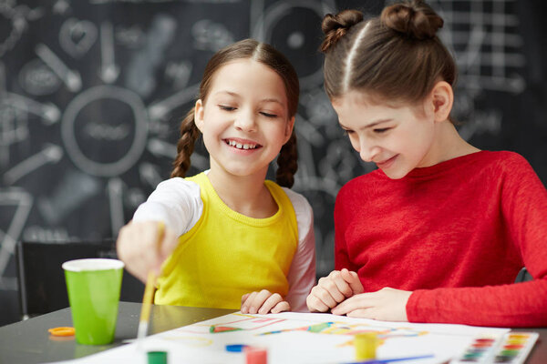 Happy girls attending drawing course or lesson