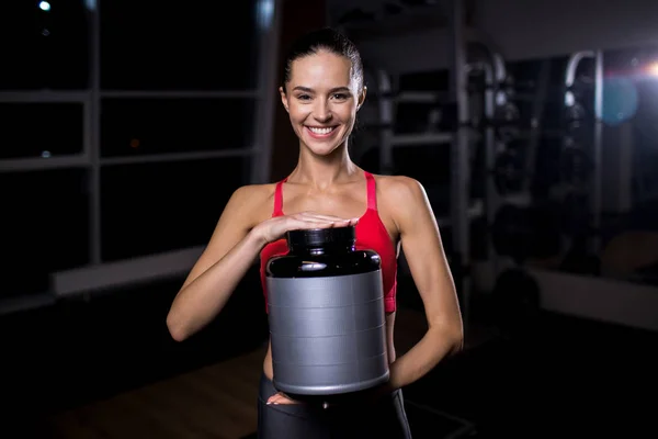 Young Sporty Woman Big Plastic Jar Looking Camera Toothy Smile — Stock Photo, Image