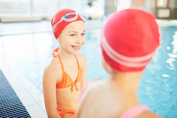 Happy Girl Swimsuit Swim Cap Goggles Looking Her Friend While — Stock Photo, Image