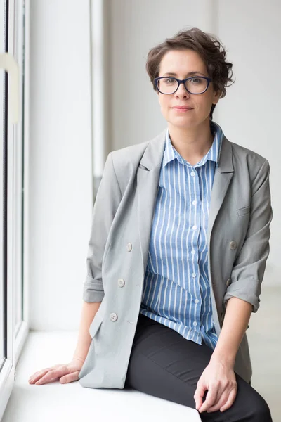 Serene Young Businesswoman Formalwear Sitting Window Sill Office Window Looking — Stock Photo, Image