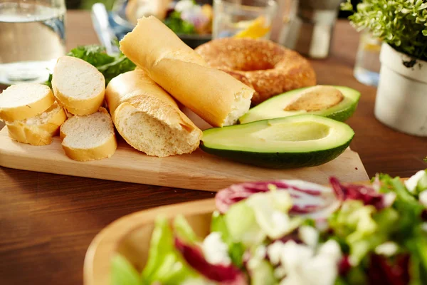 Fresh Wheat Bread Avocado Halves Wooden Board Table — Stock Photo, Image