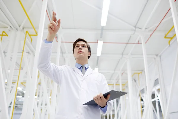 Junger Mann Uniform Zeigt Bei Der Arbeit Auf Bergbaugeräte — Stockfoto