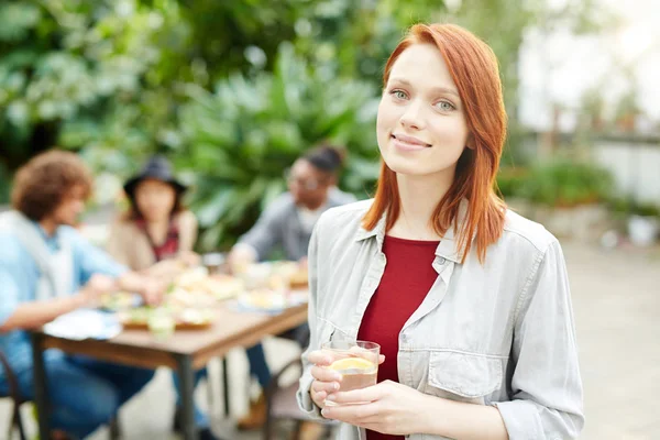 Pretty Young Girl Glass Drink Looking Camera Background Her Friends — Stock Photo, Image