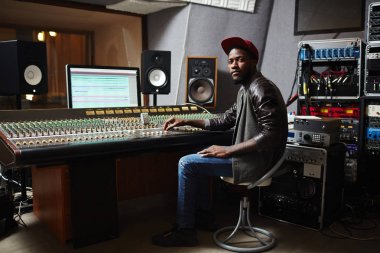 Beyzbol şapkası, kot pantolon ve geçiş panosu Studio tarafından çalışma deri ceket genç Afro-Amerikan rapçi