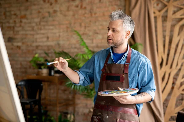 Inspired Painter Paintbrush Palette Looking Unfinished Painting While Working His — Stock Photo, Image