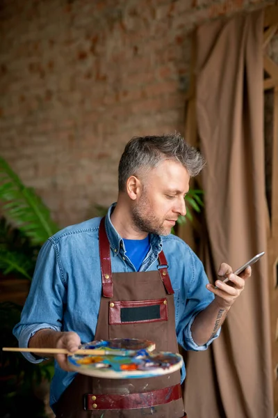 Serious Artist Workwear Looking Smartphone Screen While Surfing Net Texting — Stock Photo, Image