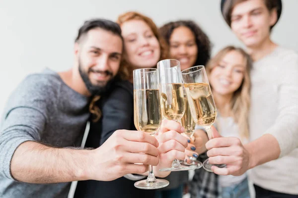 Several Flutes Sparkling Champagne Held Group Joyful Young Friends Toast — ストック写真