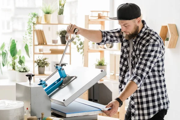 Young Contemporary Craftsman Using Special Equipment While Printing Decor Workpiece — ストック写真