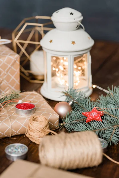 Christmas Composition Made Lantern Burning Candle Wrapped Giftboxes Threads Conifer — Stock Photo, Image