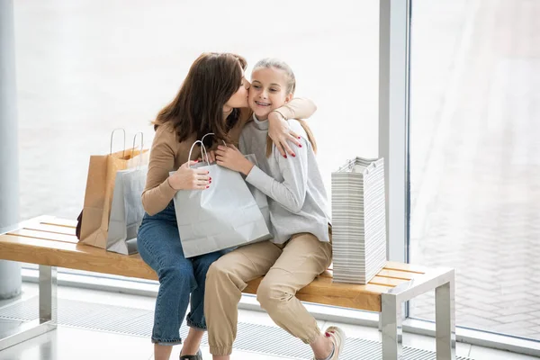 Young Affectionate Mother Kissing Her Pretty Daughter Cheek While Both — Stock Photo, Image