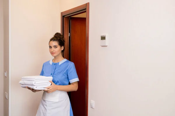 Junge Brünette Zimmermädchen Uniform Tragen Stapel Weißer Frischer Handtücher Während — Stockfoto