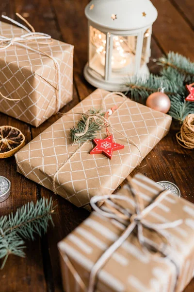 Three Wrapped Giftboxes White Lantern Burning Candle Conifer Christmas Decorations — Stock Photo, Image