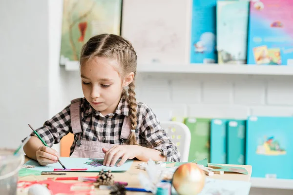 Creative Studentessa Con Pennello Seduto Scrivania Disegno Immagine Natale Con — Foto Stock