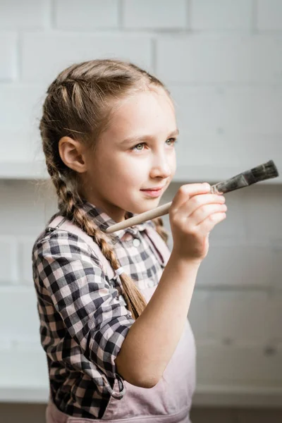 Creative Adorable Schoolgirl Holding Paintbrush While Going Paint Picture Studio — Foto Stock