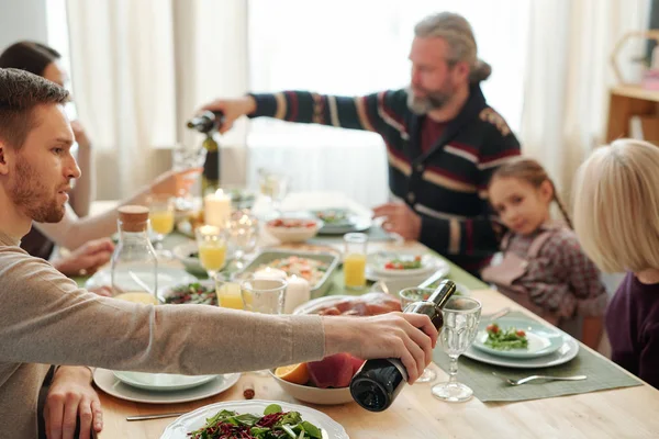 Young Man Pouring Wine Glass His Mom Sitting Front Him — Stockfoto