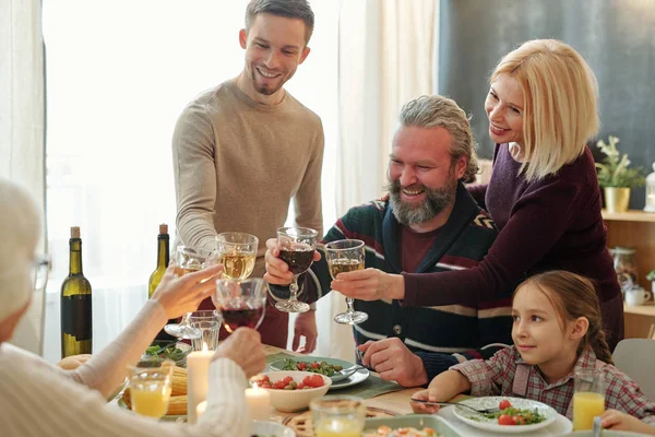 Happy Mature Young Family Members Toasting Wine Homemade Food Served — Stok fotoğraf