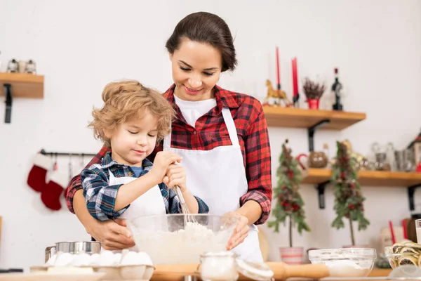 Young Female Holding Bowl Flour Eggs While Her Son Whisking — Stockfoto