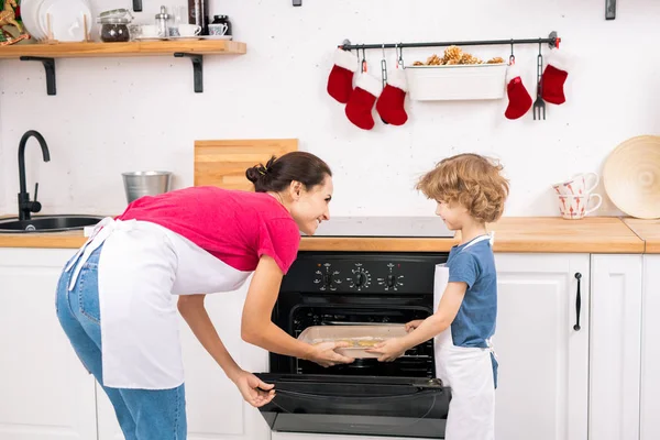 Little Boy Apron Helping His Mom Put Tray Raw Cookies — Stockfoto