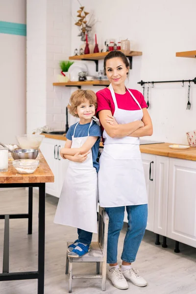 Happy Adorable Child His Mother White Aprons Standing Close One — Stockfoto