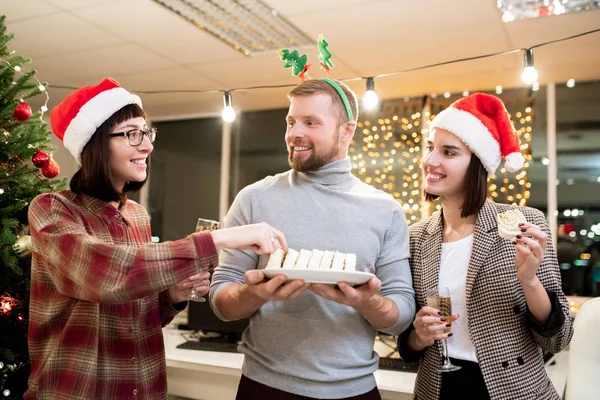 Happy Young Businessman Offering Dessert His Pretty Colleagues Champagne Christmas — 图库照片