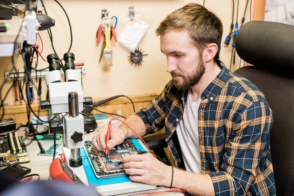 Young Serious Mechanic Two Soldering Irons Repairing Demounted Touchpad Workplace — Stock Photo, Image